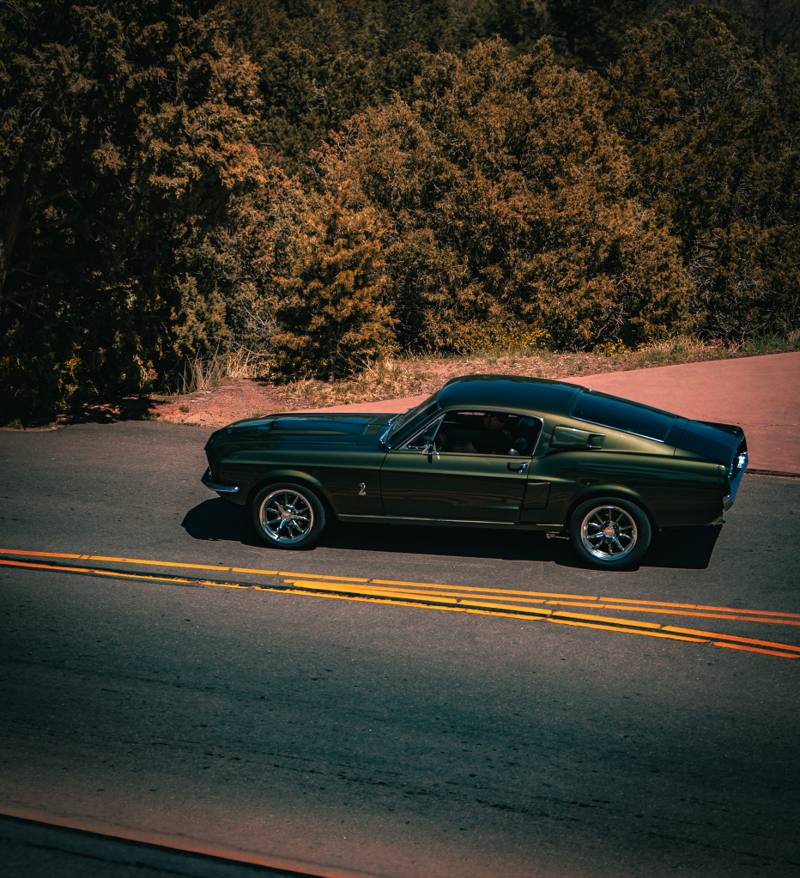 Classic Ford Mustang photographed on an open road in Colorado