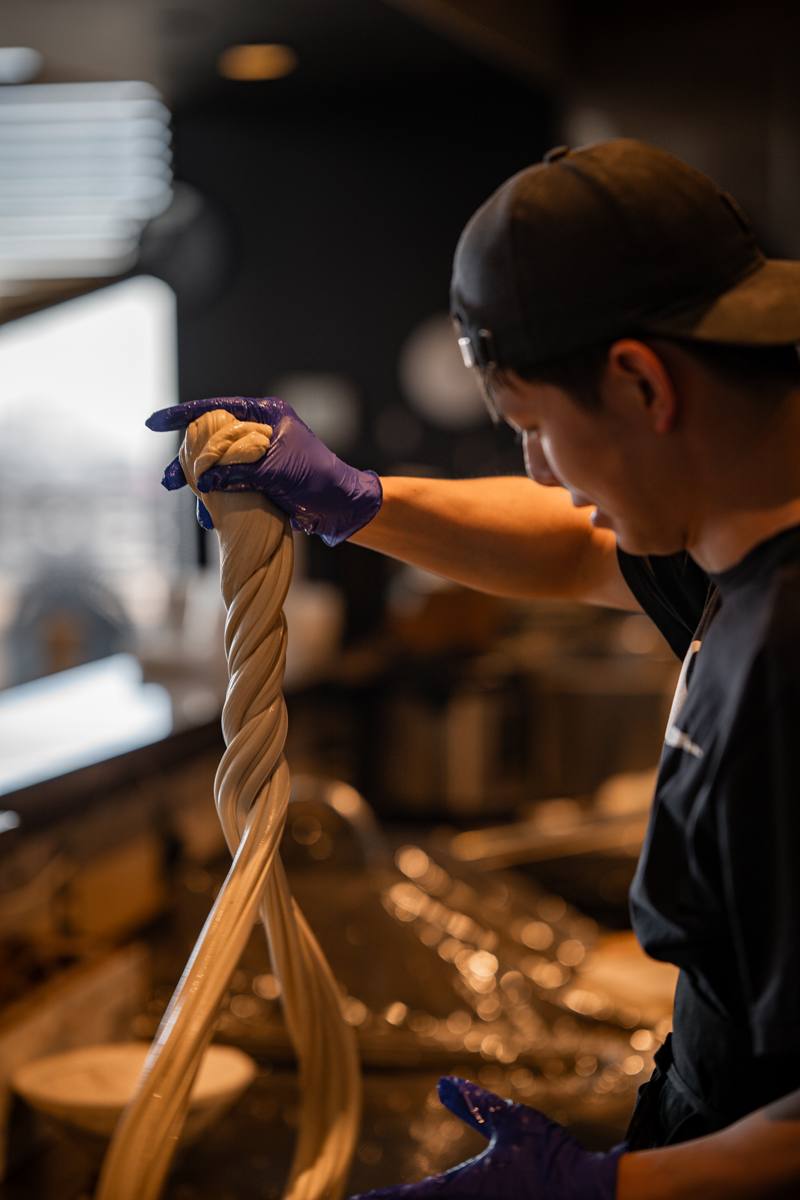 Chef hand-pulling fresh noodles at Lan&rsquo;s Noodles & Dumplings in Denver