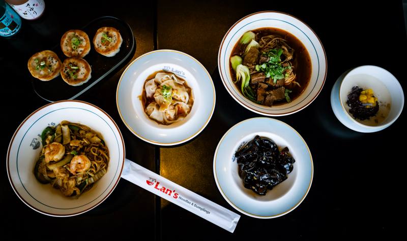Overhead view of plated dishes at Lan&rsquo;s Noodles & Dumplings in Denver